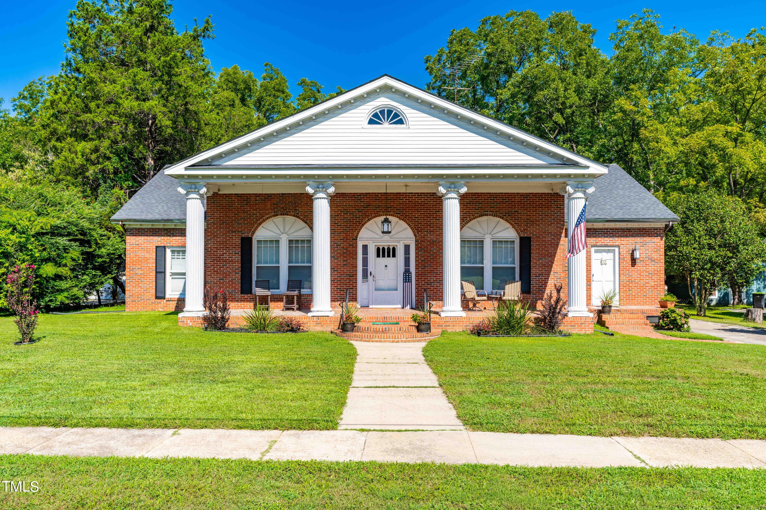 a front view of a house with garden