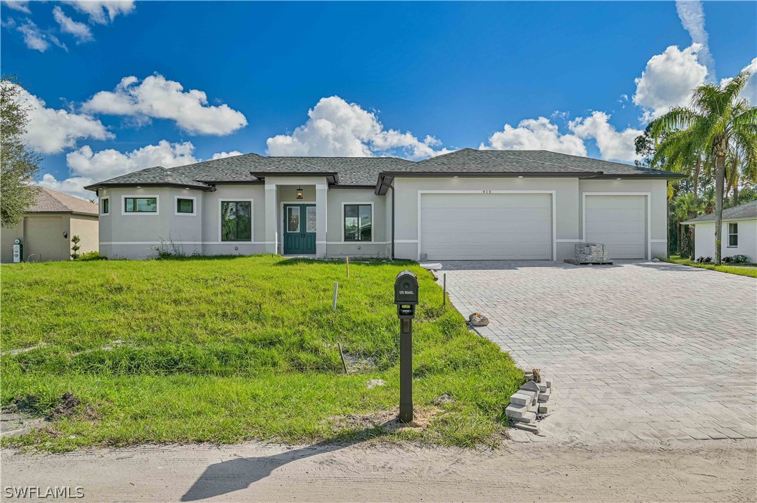 a front view of a house with a yard and garage