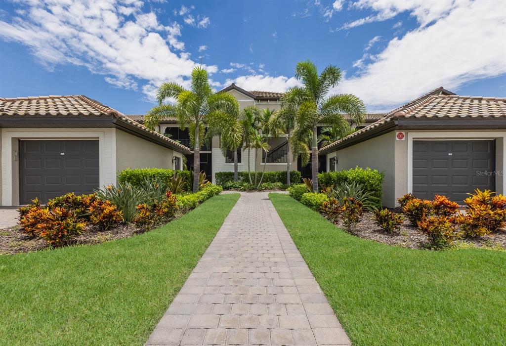 a front view of a house with a yard and outdoor seating