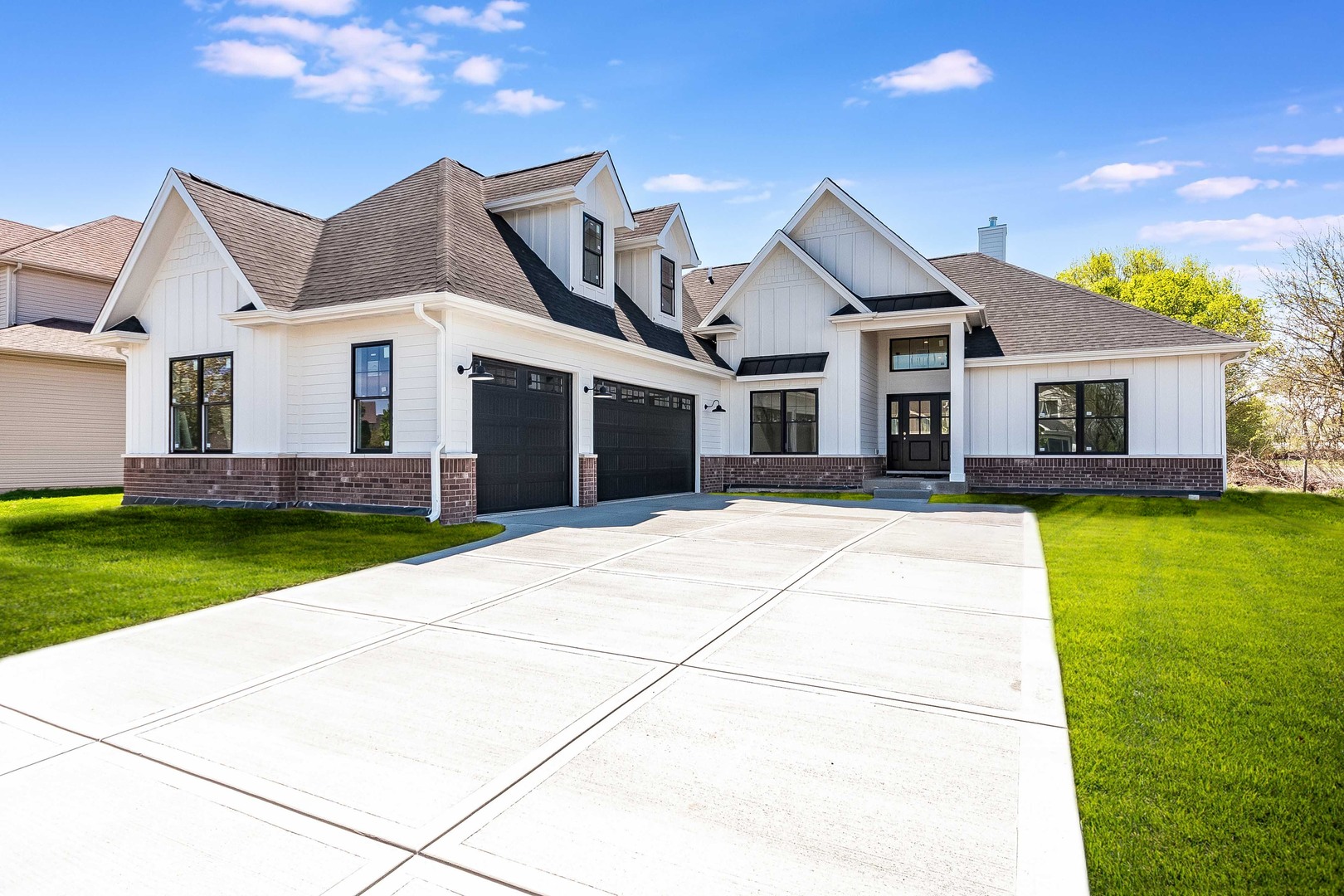 a front view of a house with a garden and yard