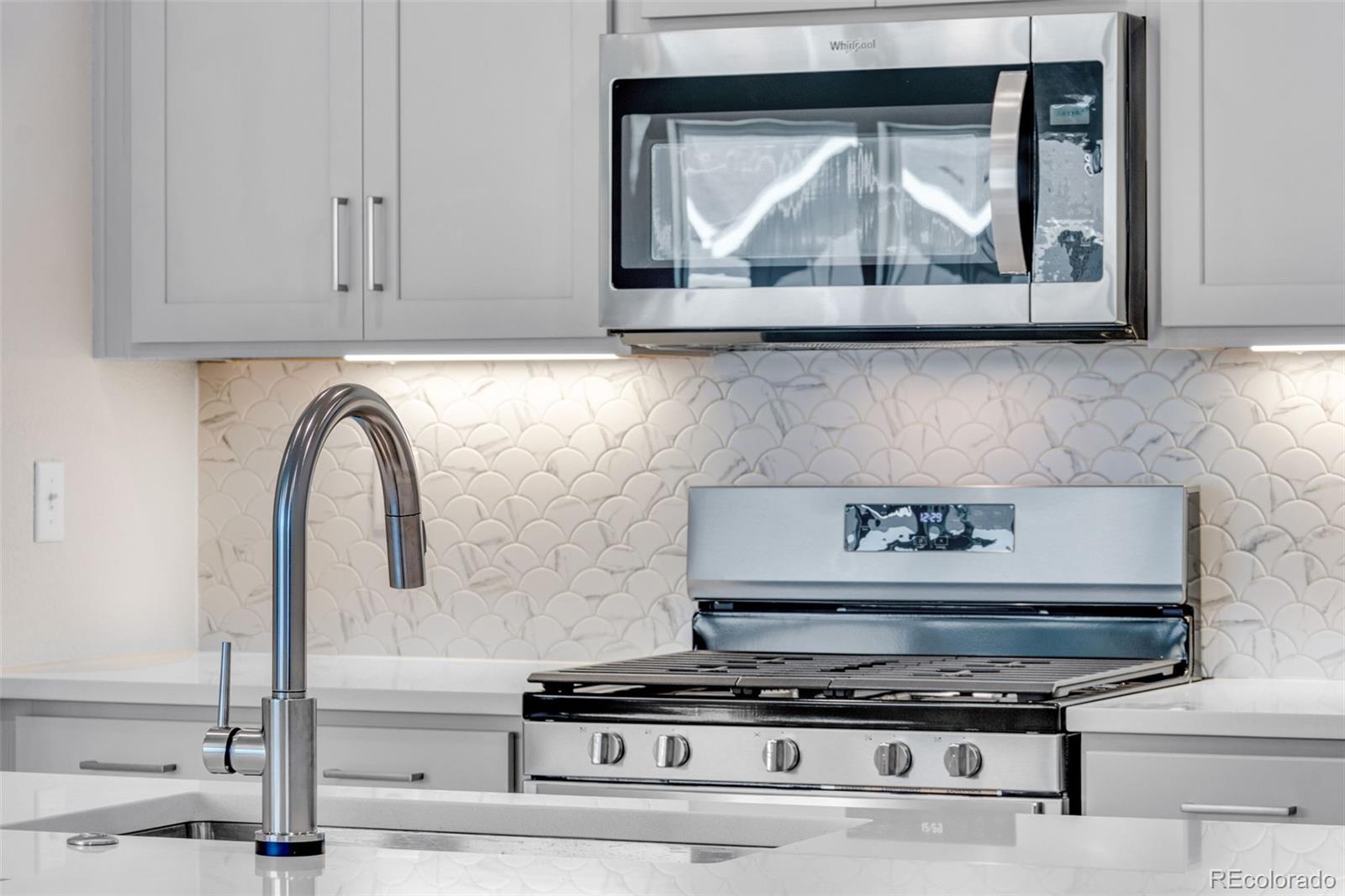 a stove top oven sitting inside of a kitchen