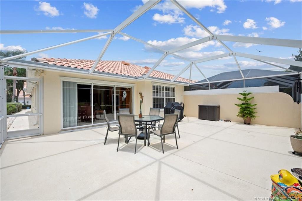 a patio with yard and outdoor seating