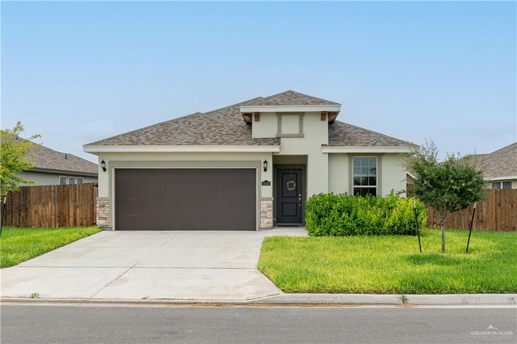 Prairie-style house with a garage and a front yard