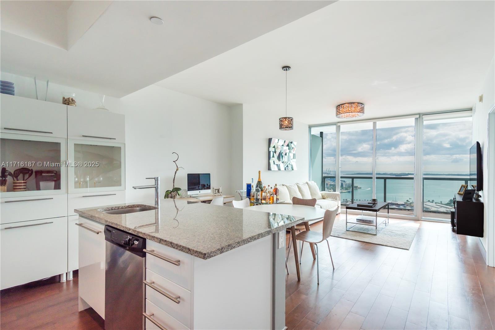 a kitchen with a table chairs stove and wooden floor