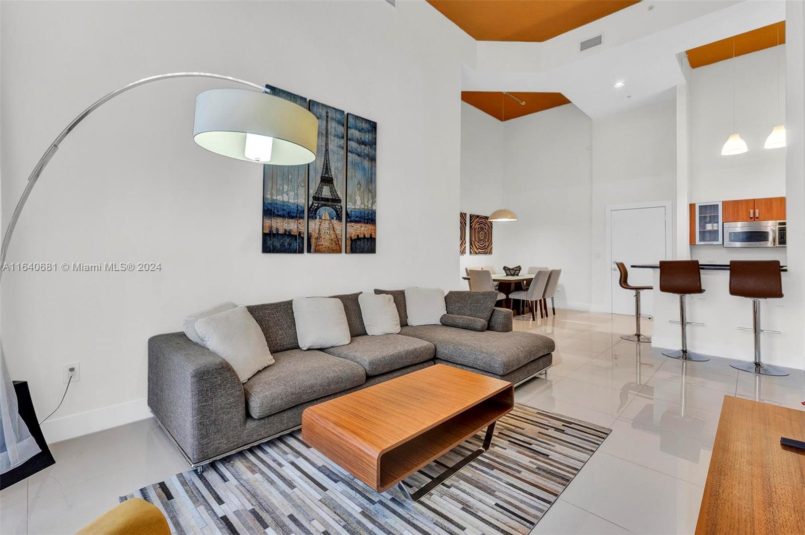 a living room with furniture a rug and a painting on the wall