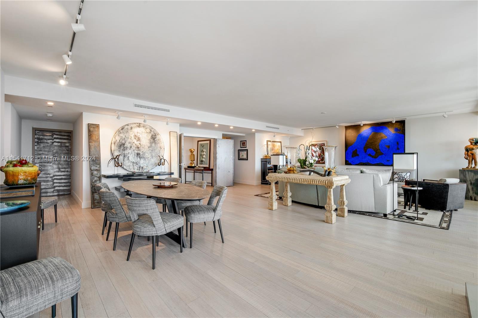 a living room with furniture a dining table and a fireplace