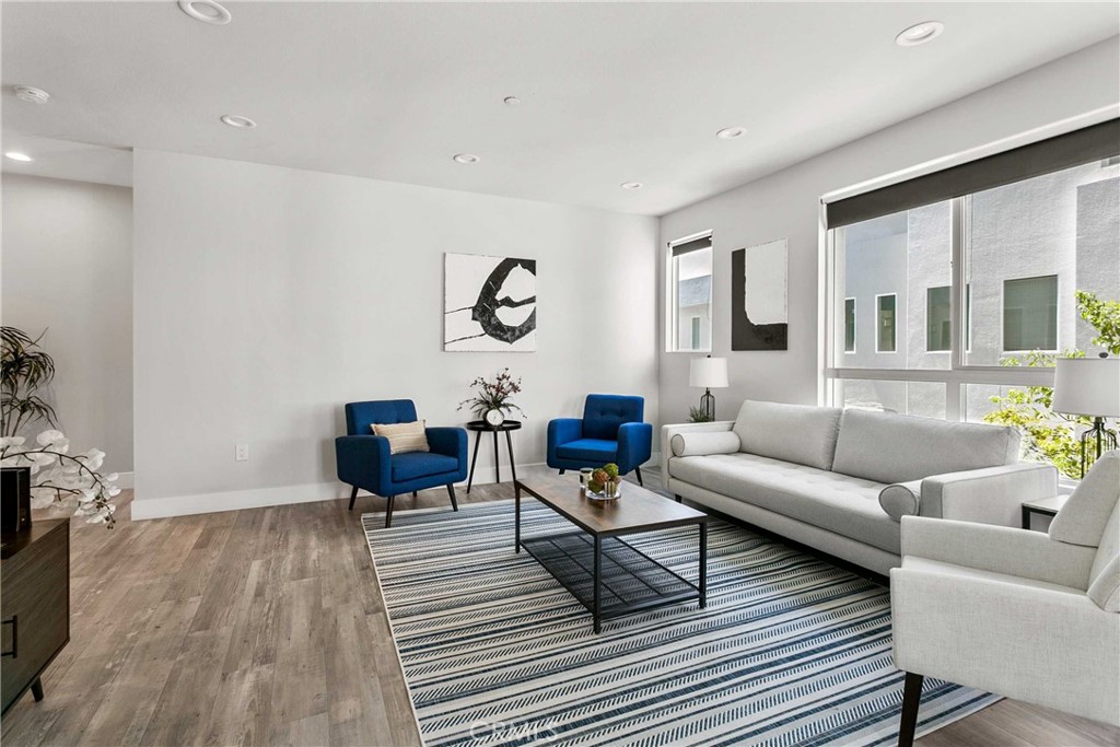 a living room with furniture and wooden floor