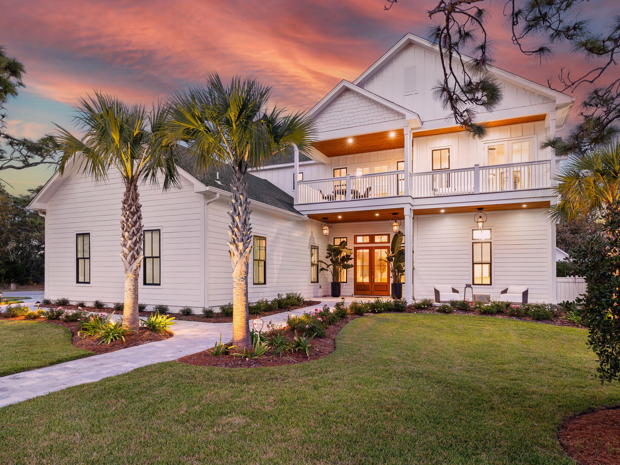 a row of palm trees in front of house