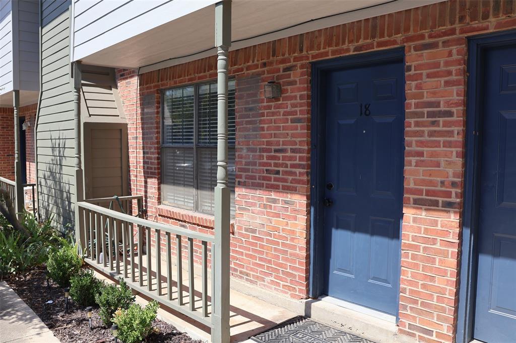 a view of a brick house with a large window