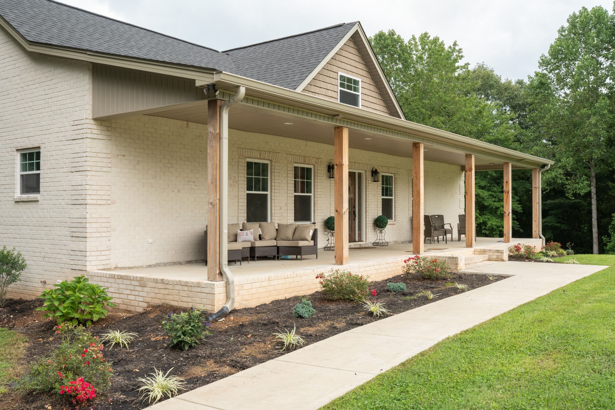 a front view of a house with garden and porch