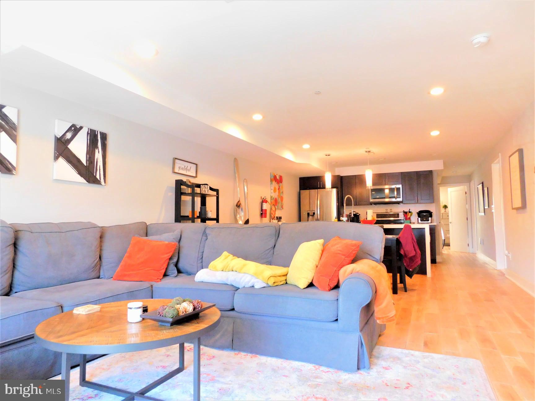 a living room with furniture kitchen and a table