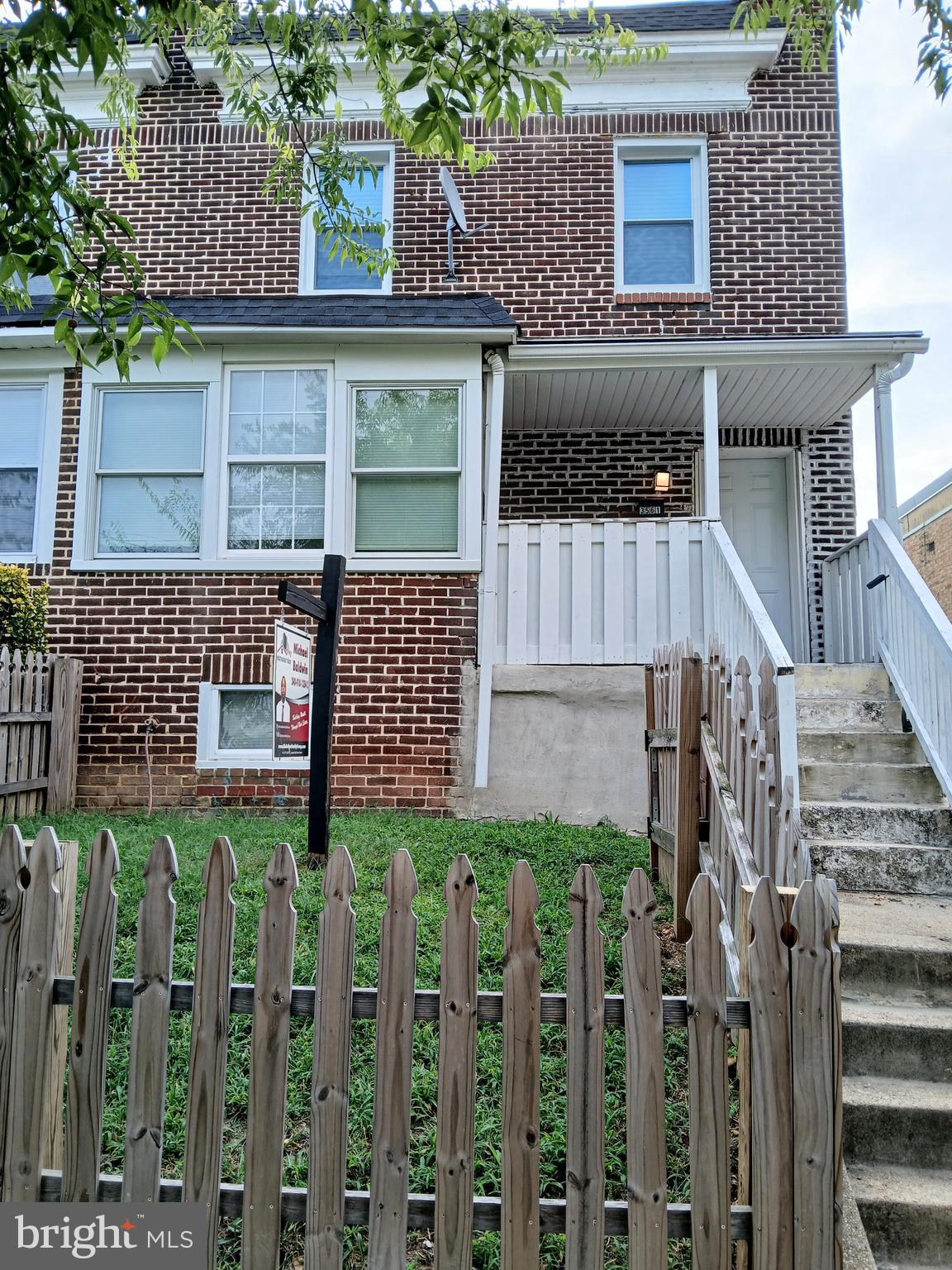 a front view of a house with a fence