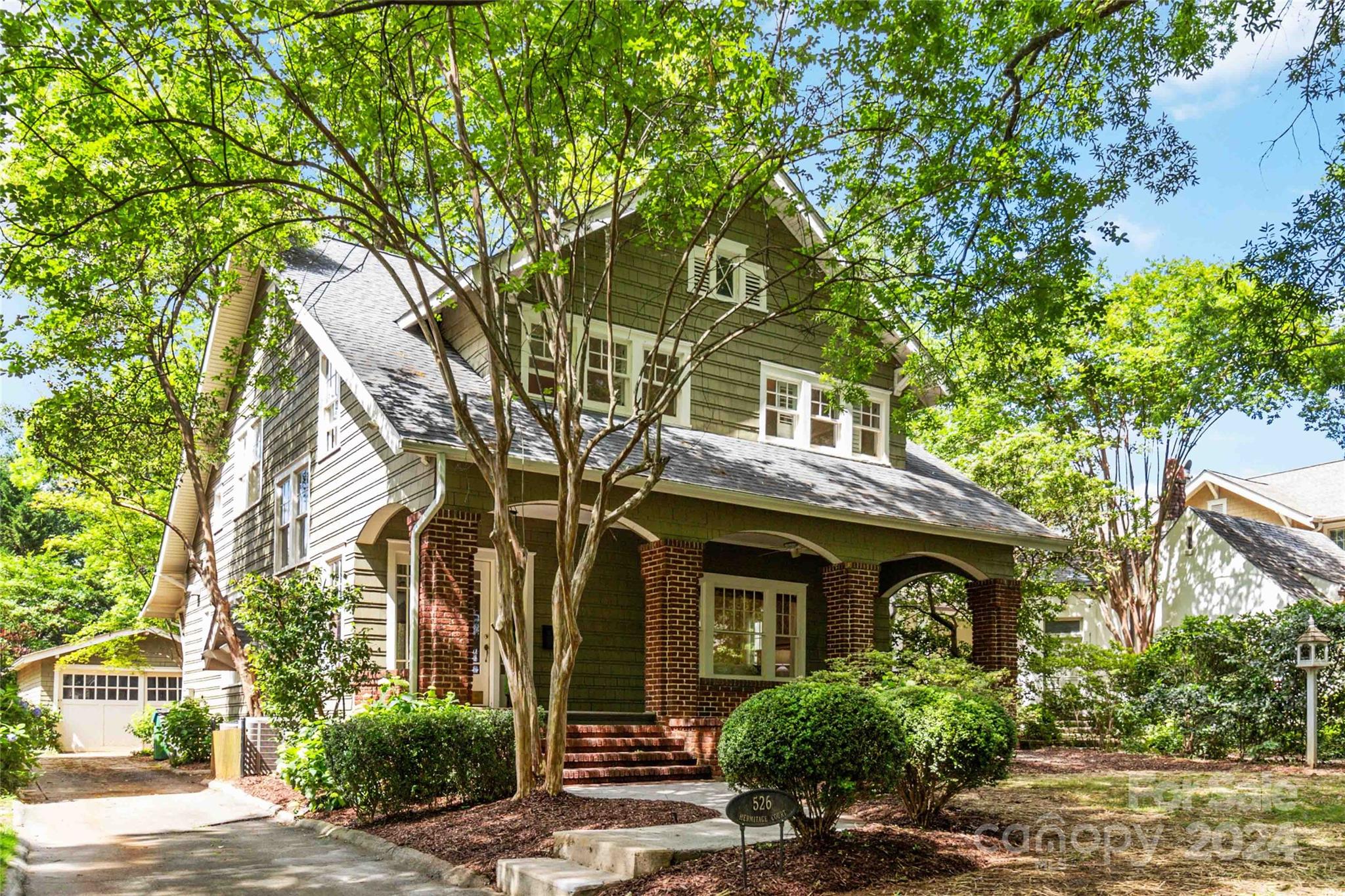 front view of a house with a tree