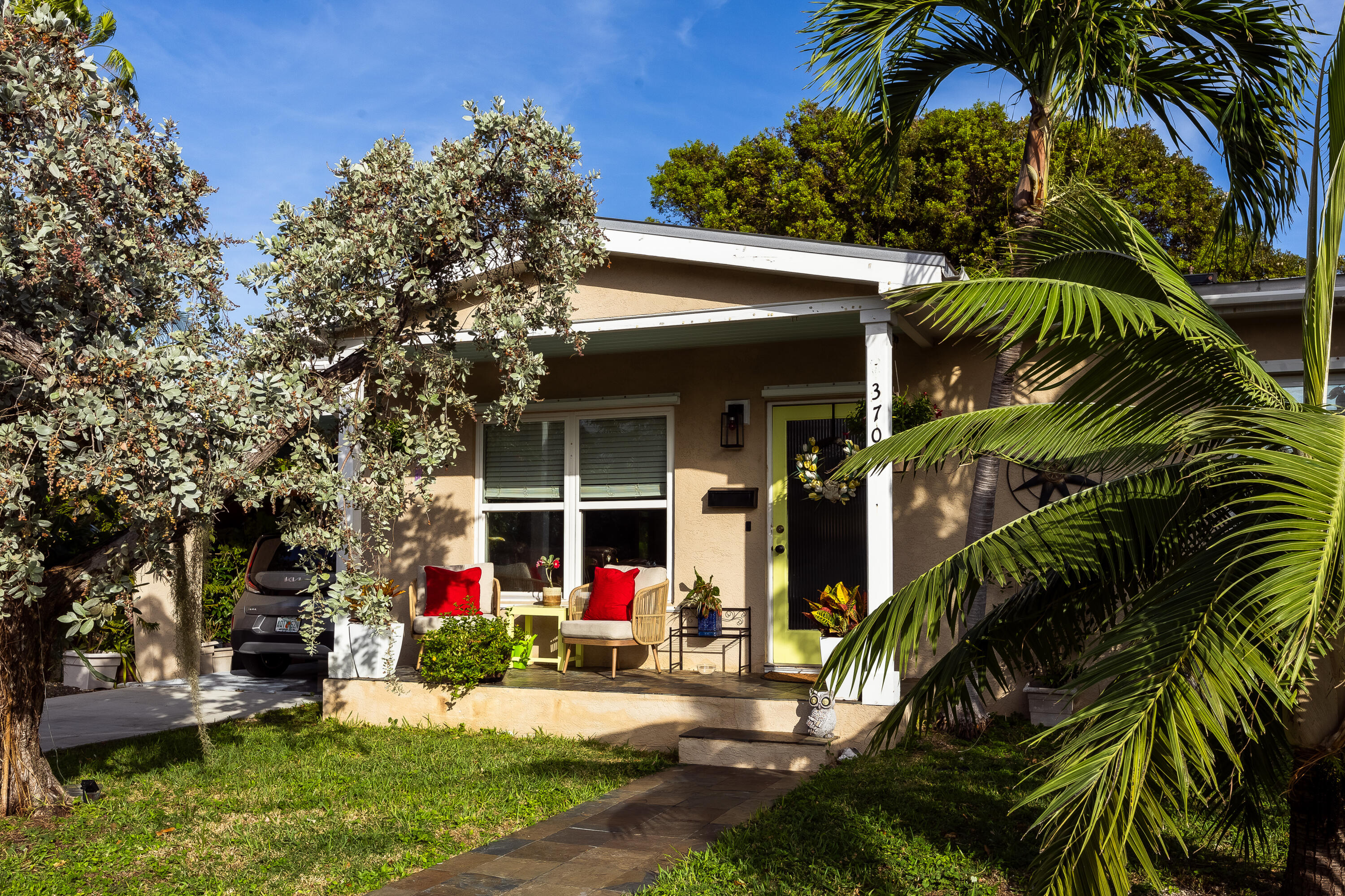 a view of a house with a tree and plants