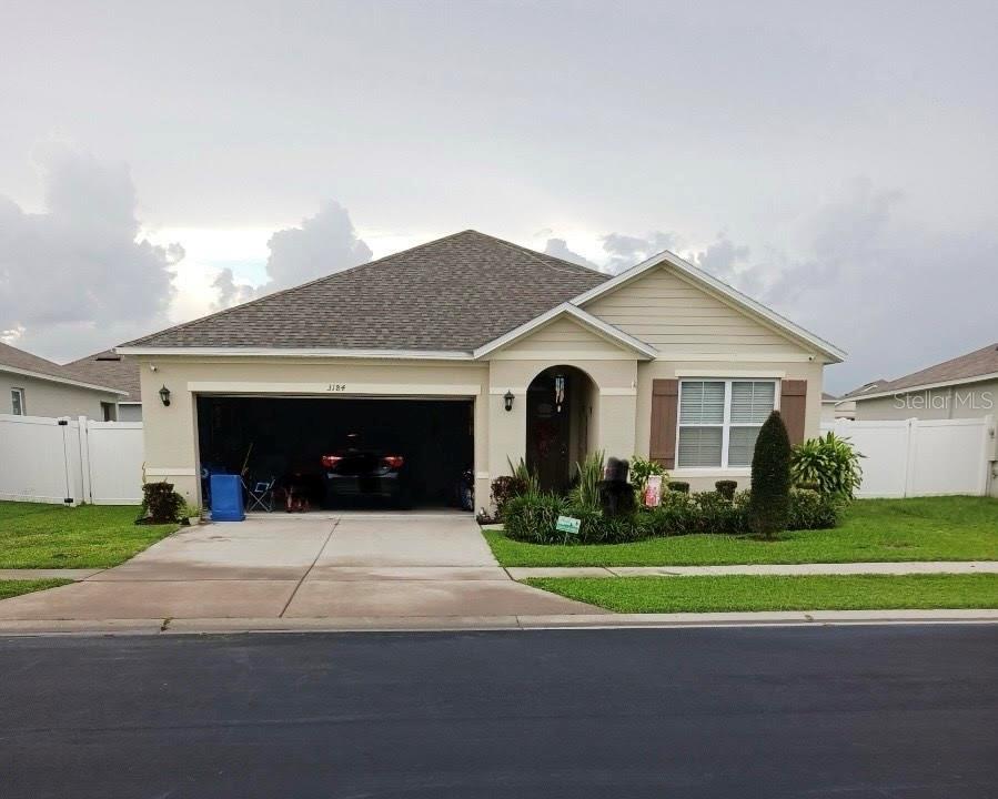 a front view of a house with a yard and garage