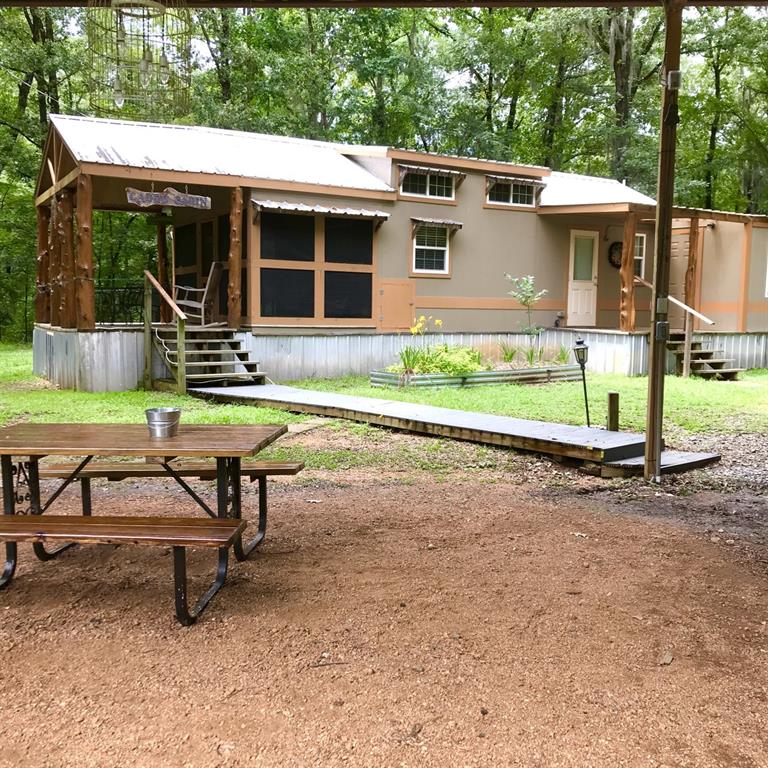 a view of a house with backyard porch and sitting area