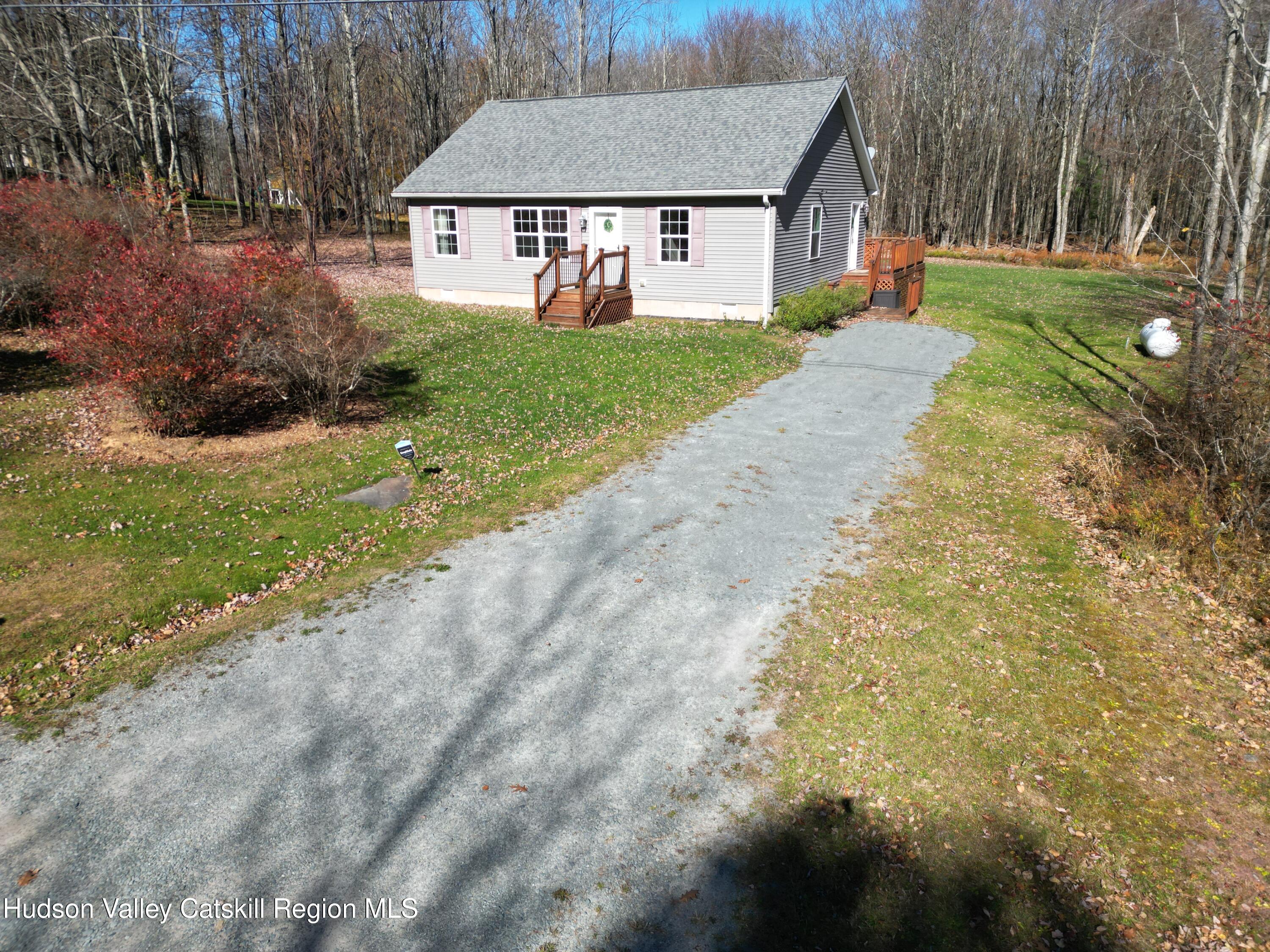 a view of a house with a yard and tree s