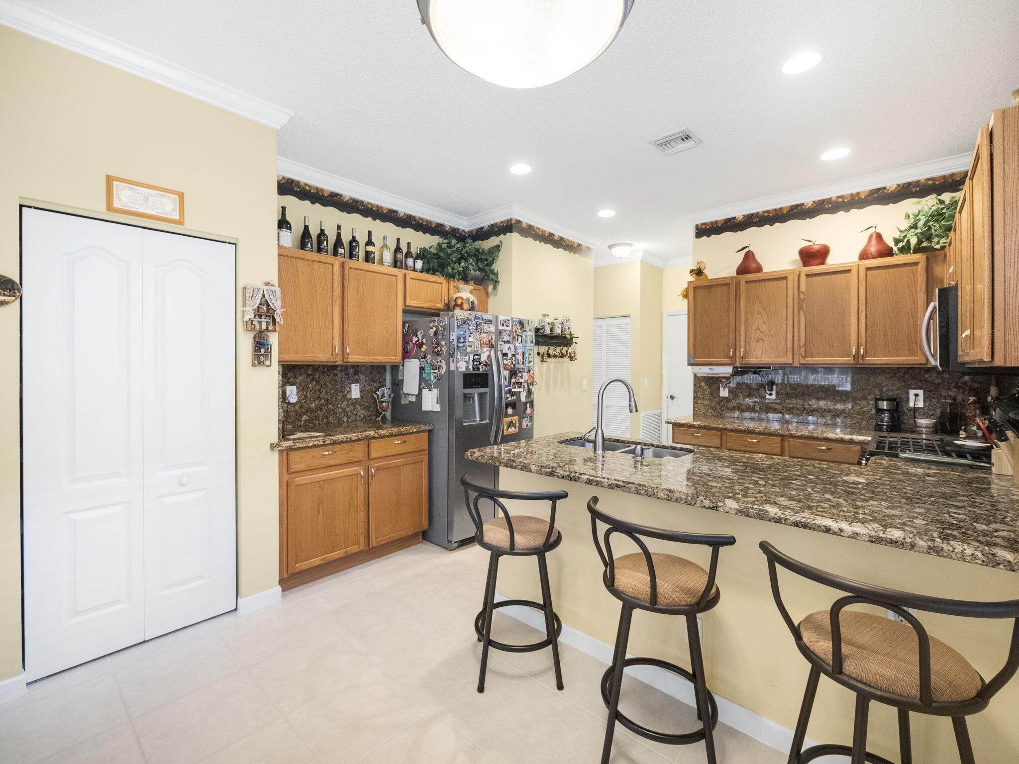 a kitchen with stainless steel appliances granite countertop a sink and cabinets