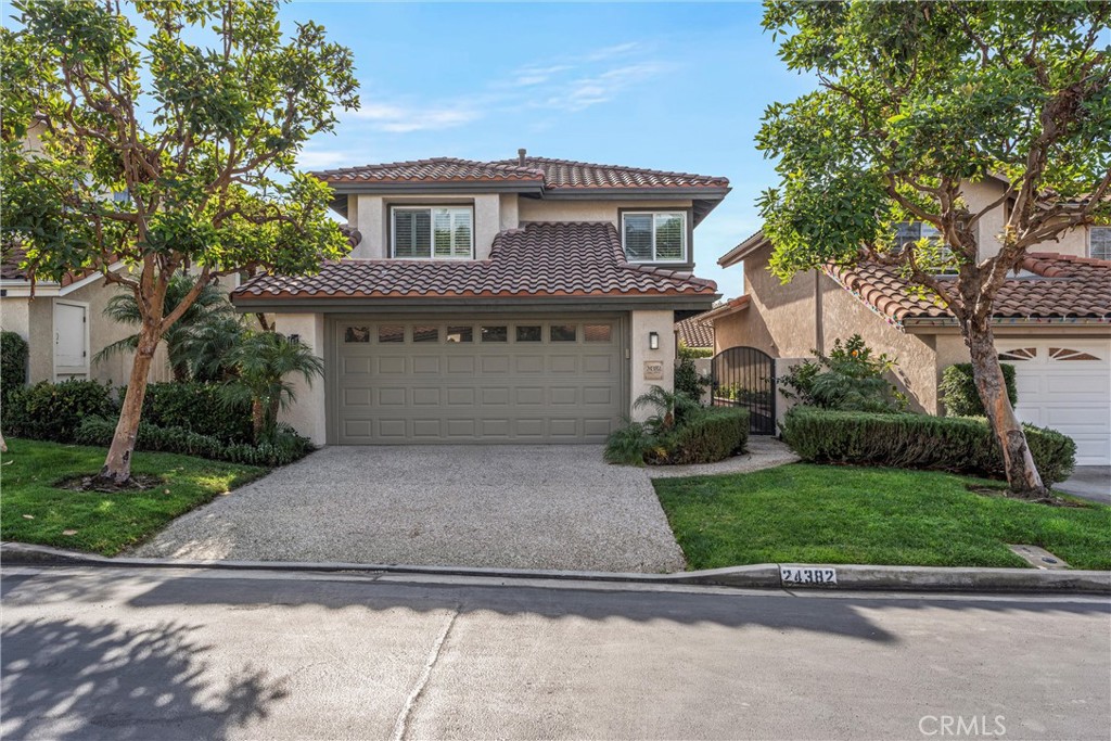 a front view of a house with a yard and a garage