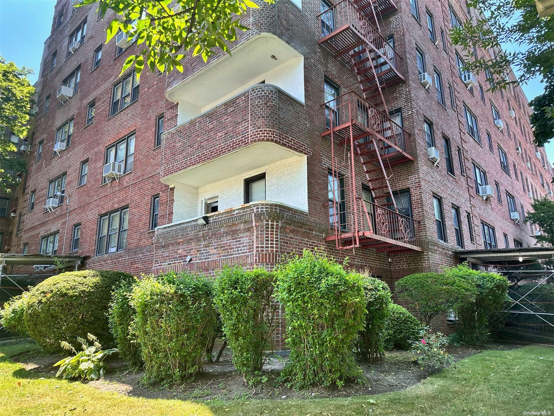 a front view of a building with a garden