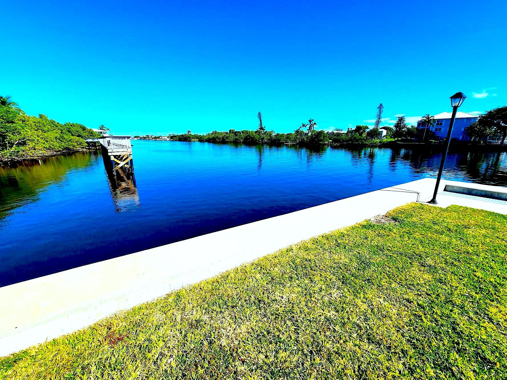 a view of a lake with houses in the back