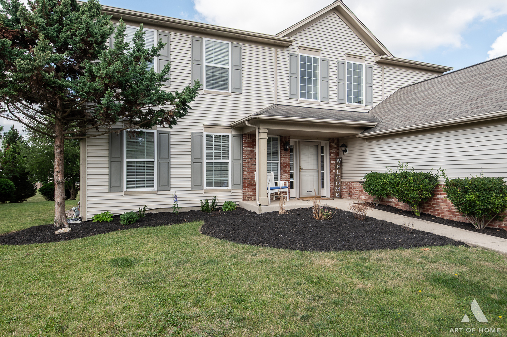 a front view of a house with a yard