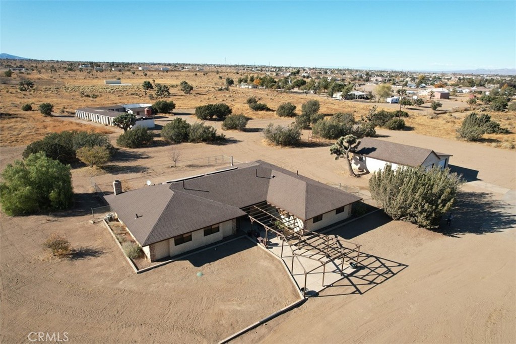 an aerial view of a house with a yard and ocean view