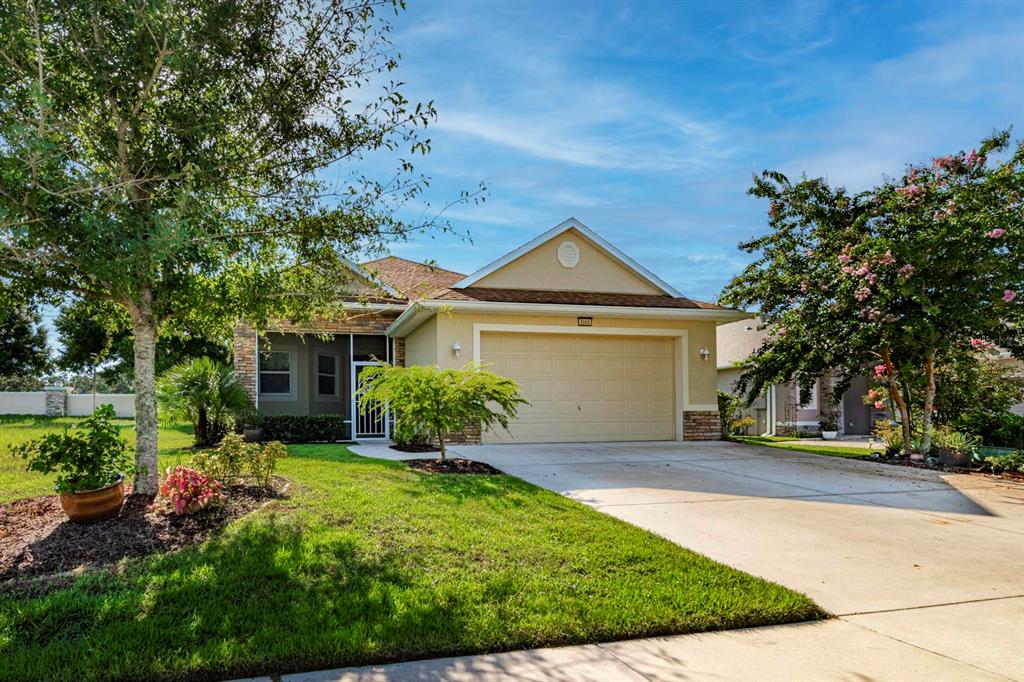 a front view of a house with a yard and garage