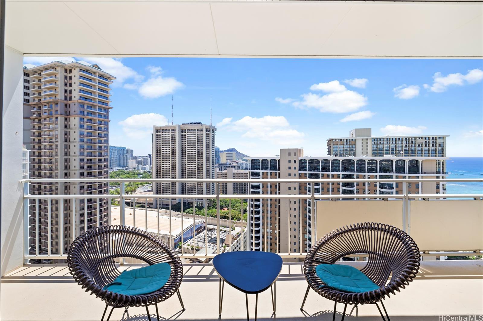 a view of a chairs and table in a balcony