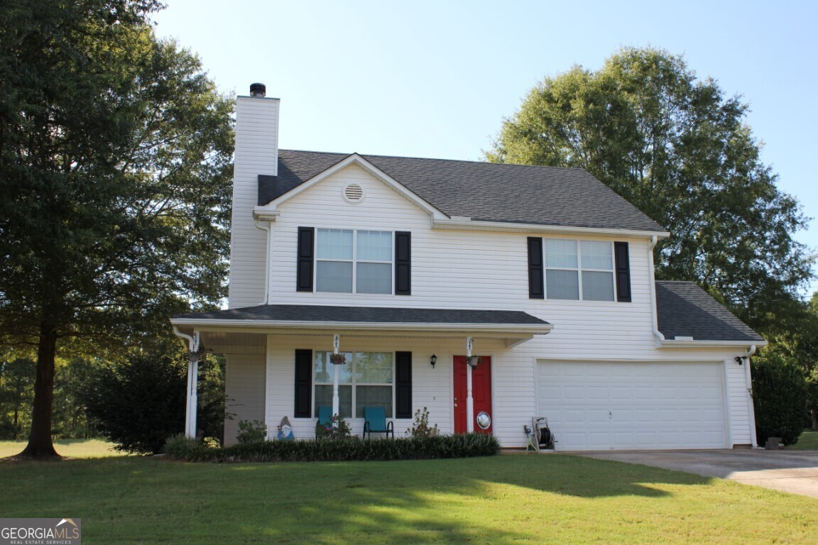 a front view of house with yard and green space