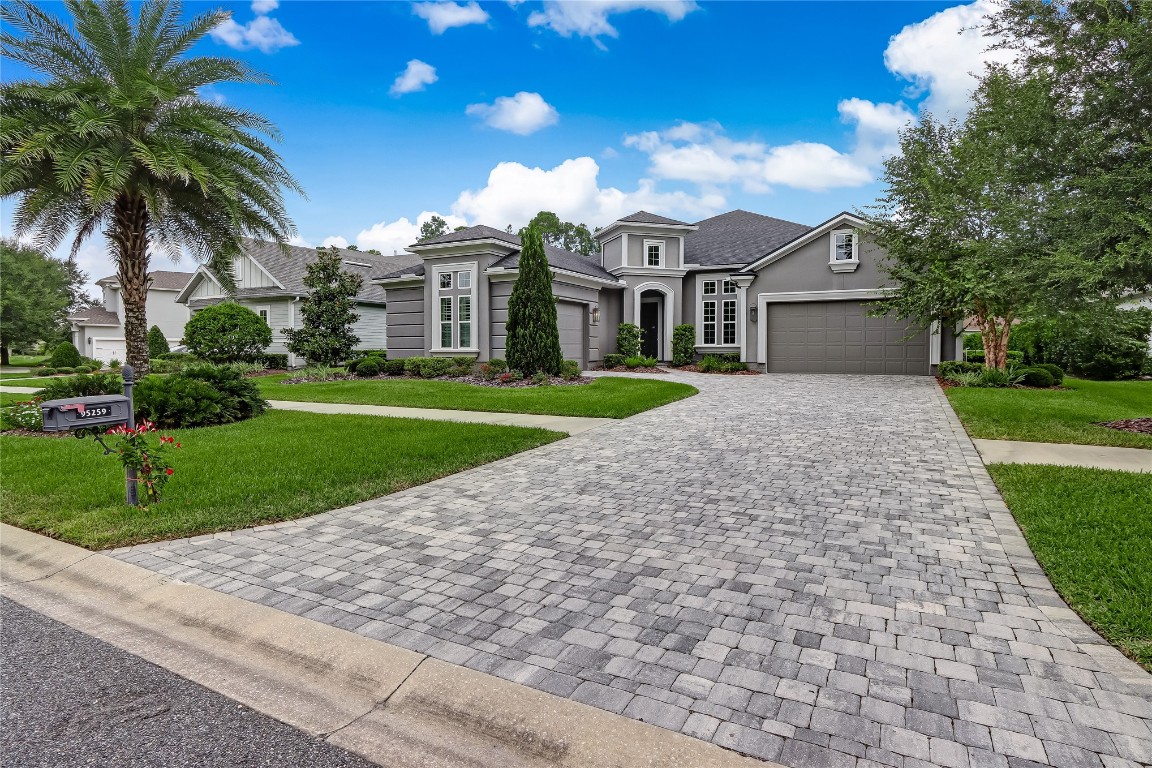 a front view of a house with a yard and garage