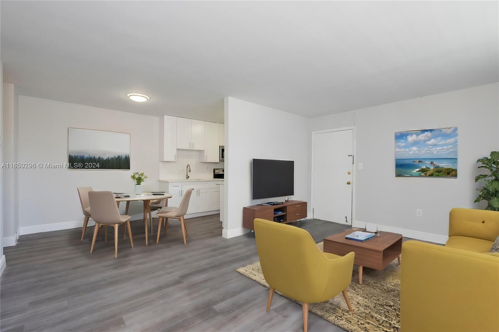 a living room with furniture a dining table and a flat screen tv