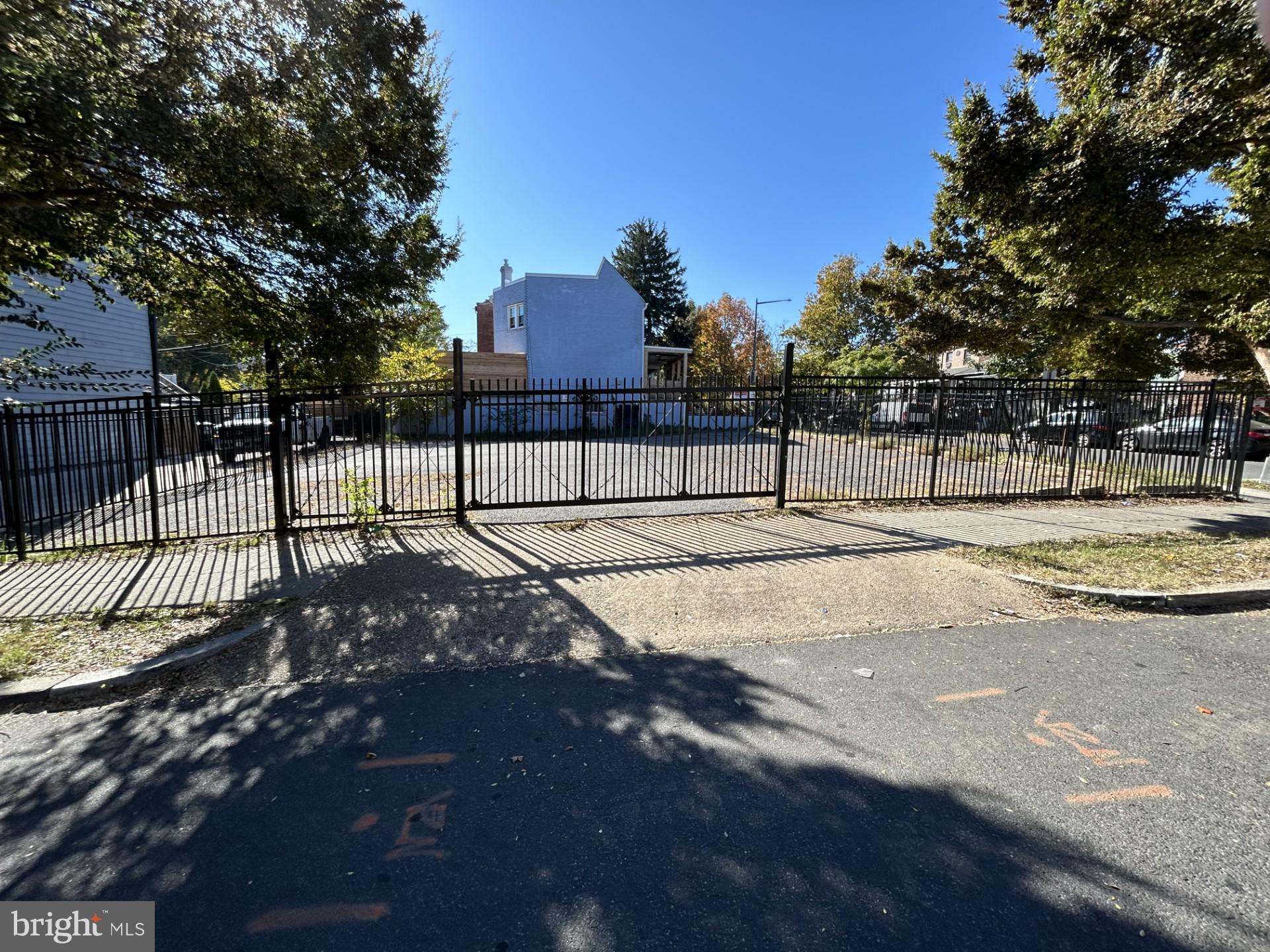 a view of a yard with wooden fence