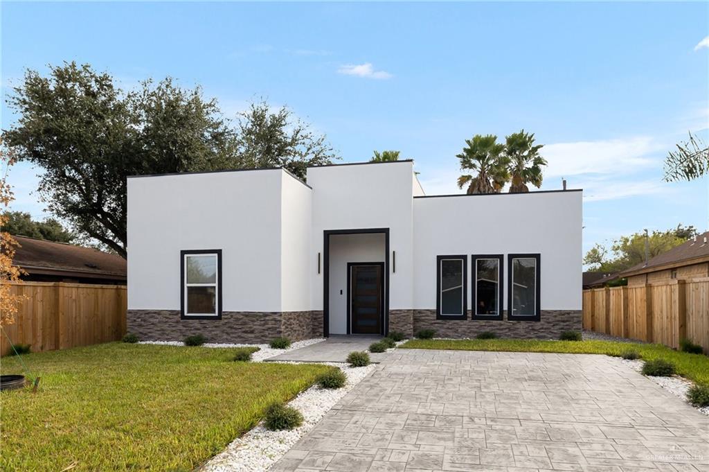 Contemporary home featuring a front lawn