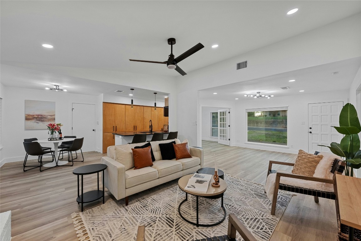 a living room with furniture and a wooden floor