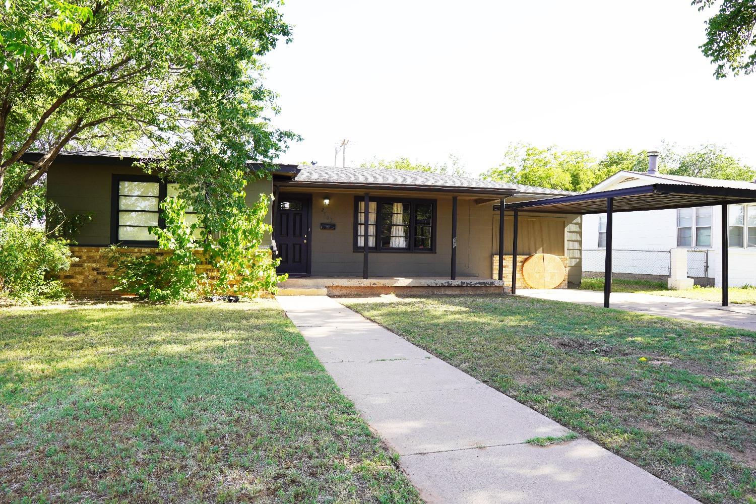 front view of a house with a yard