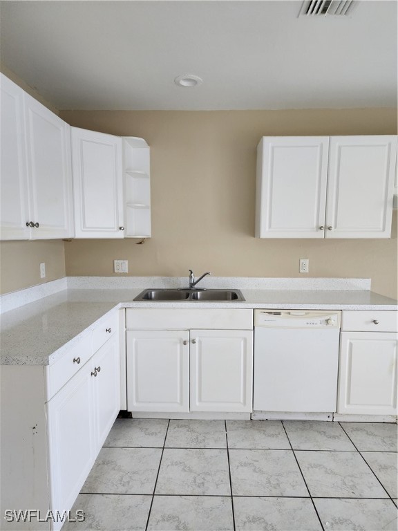 a kitchen with granite countertop white cabinets and stainless steel appliances