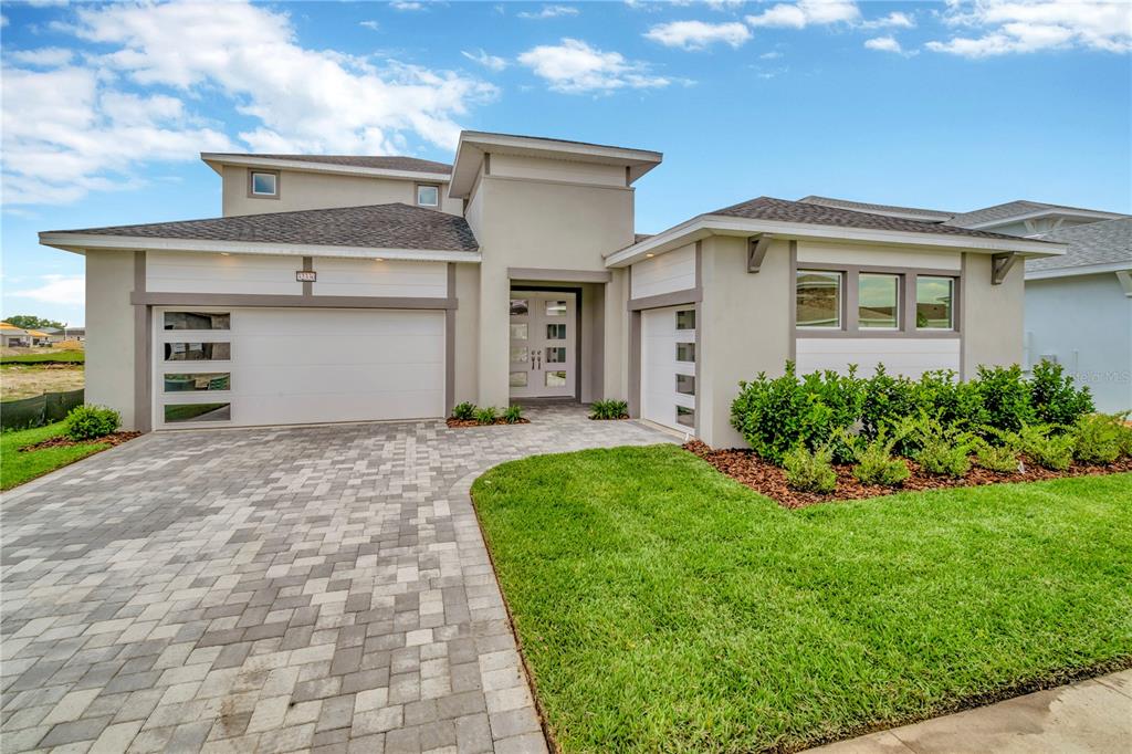 a front view of a house with a yard and garage