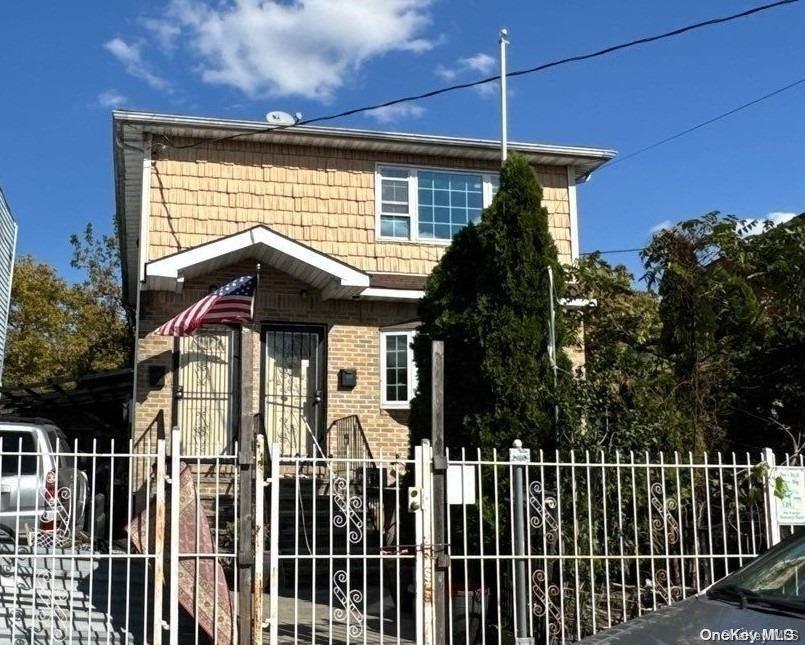 a view of a house with a small yard and wooden floor and fence