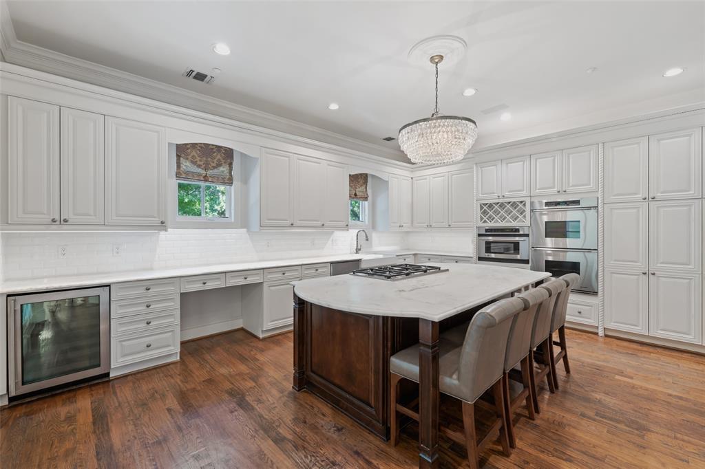 a view of a kitchen with a dining table chairs and wooden floor