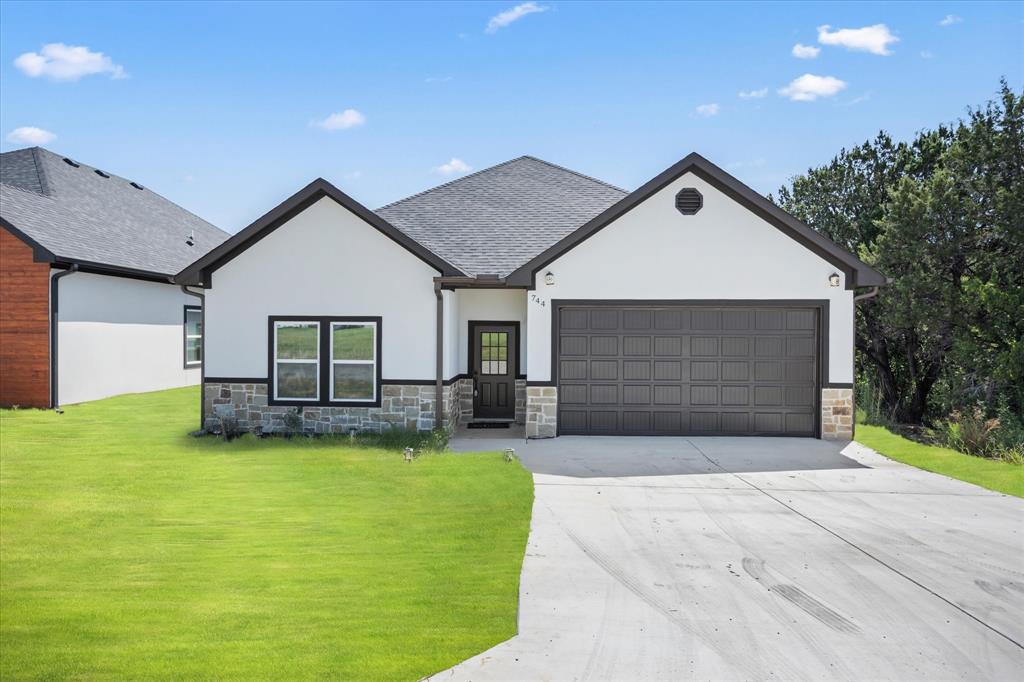 a view of a house with a yard and garage