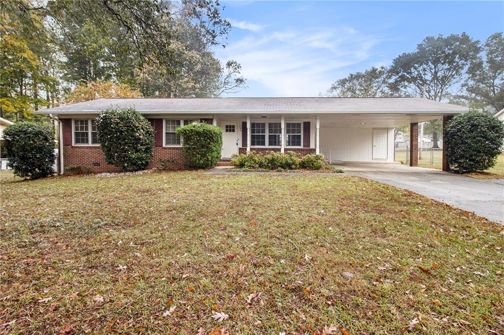 front view of a house with a big yard and potted plants