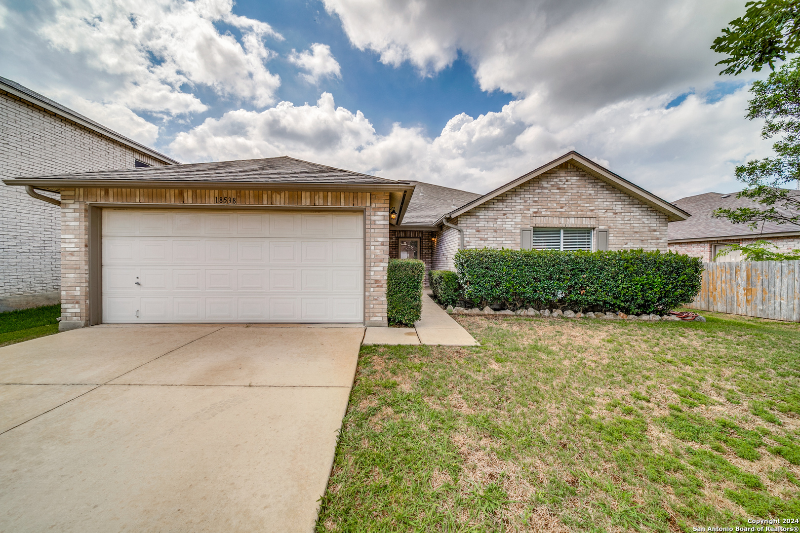 a view of a house with a yard and garage