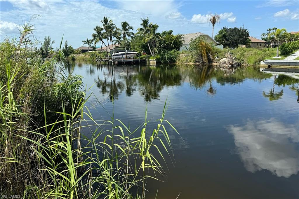 a view of a lake with a house in the background