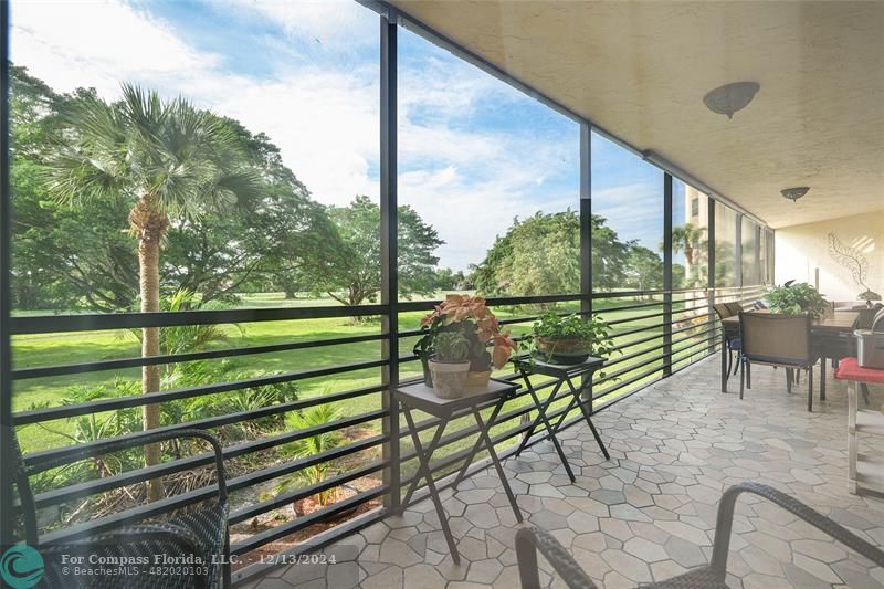 a view of a chairs and table in patio with a yard