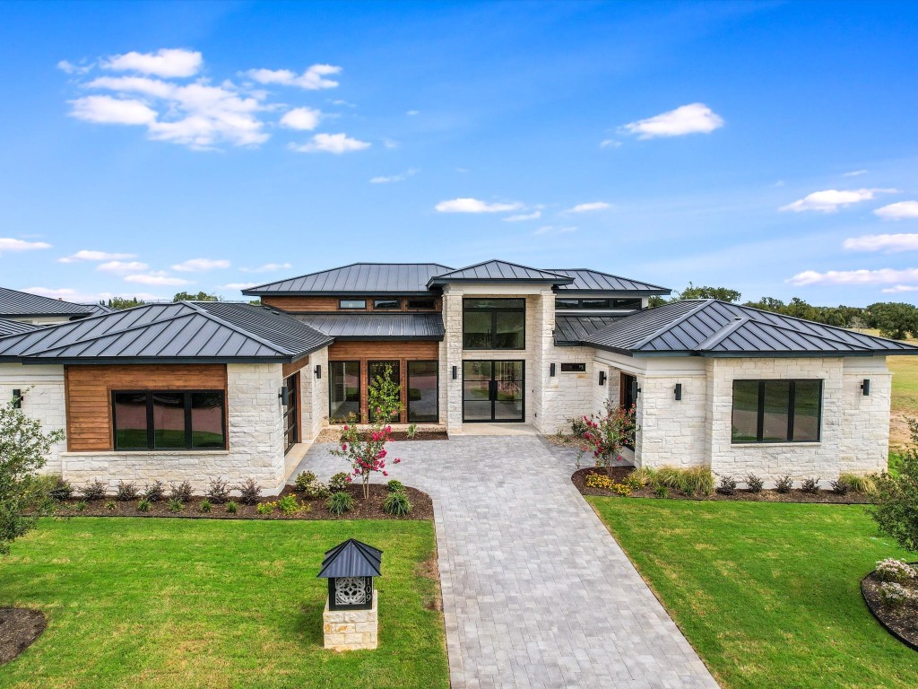 a front view of a house with a garden and yard