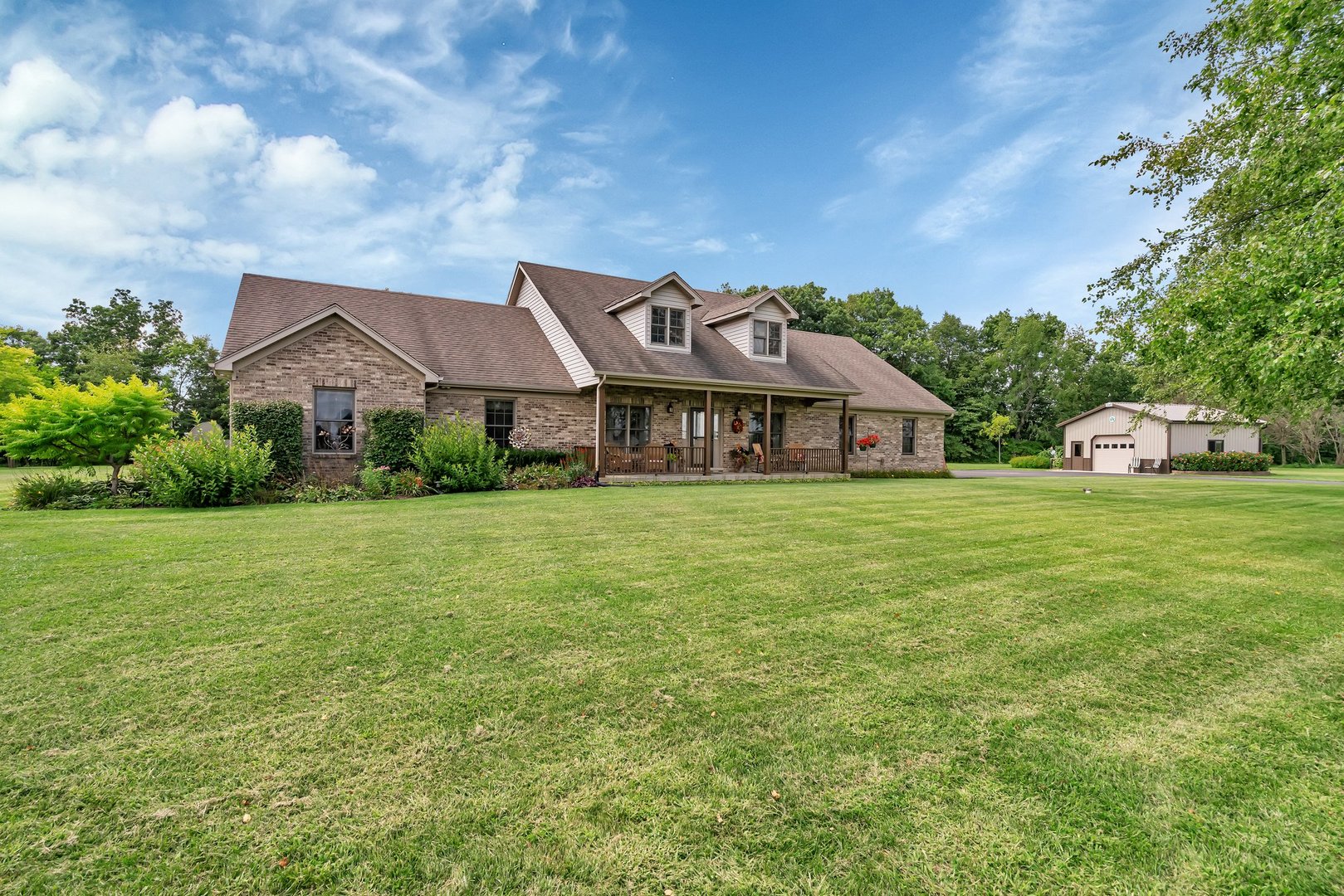 a front view of house with yard and car parked