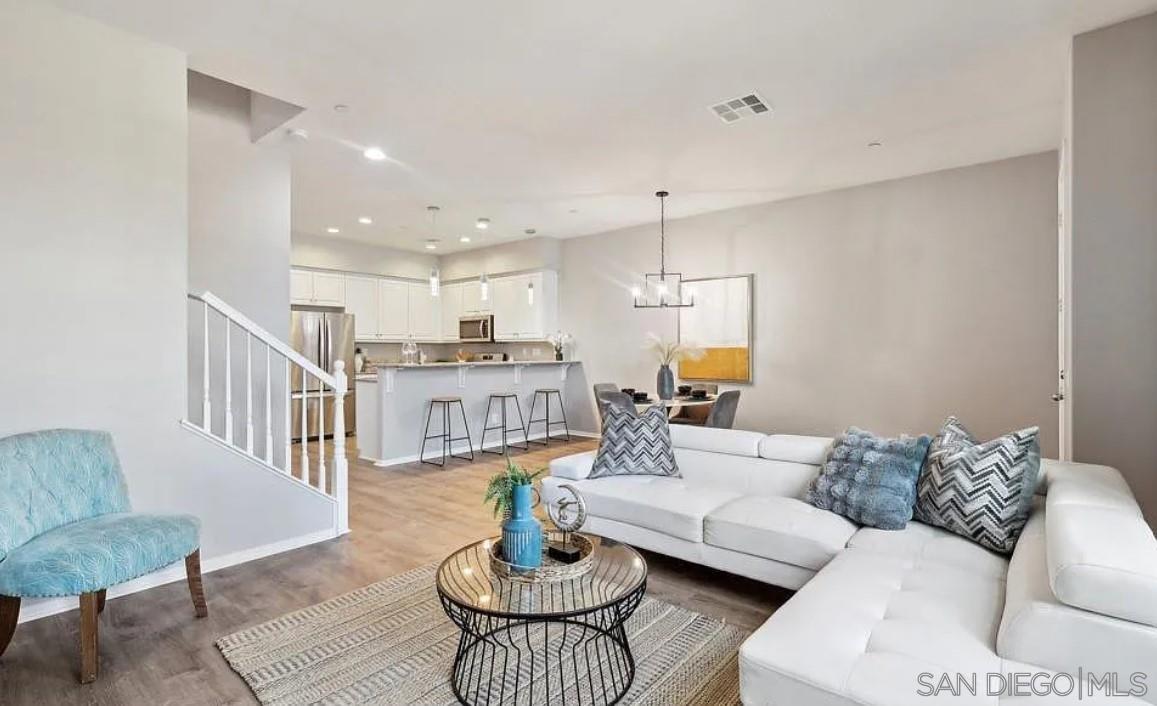 a living room with furniture kitchen view and a table