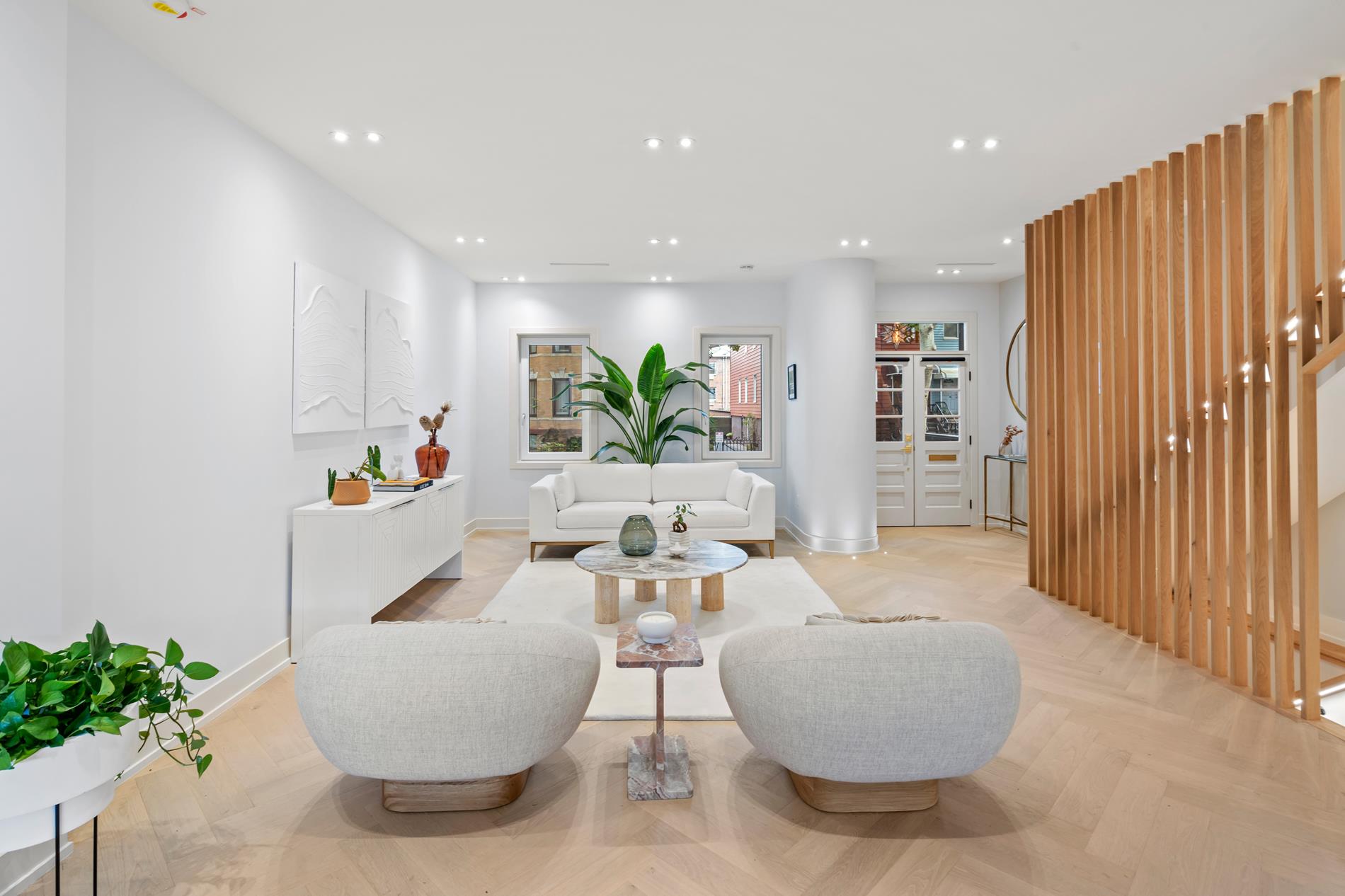 a living room with furniture and a potted plant