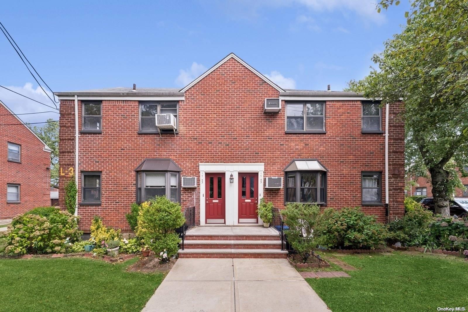 front view of brick house with a yard